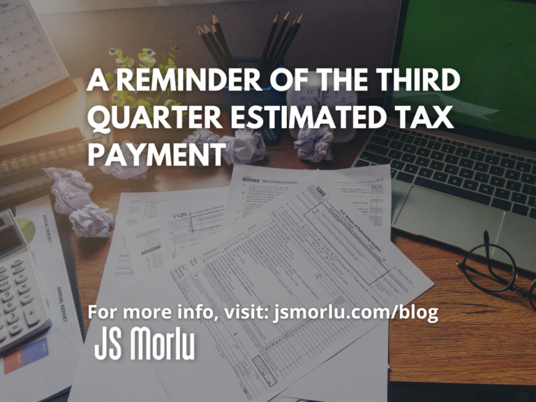 Open laptop, overflowing papers, and a tax form – third quarter estimated tax payment.
