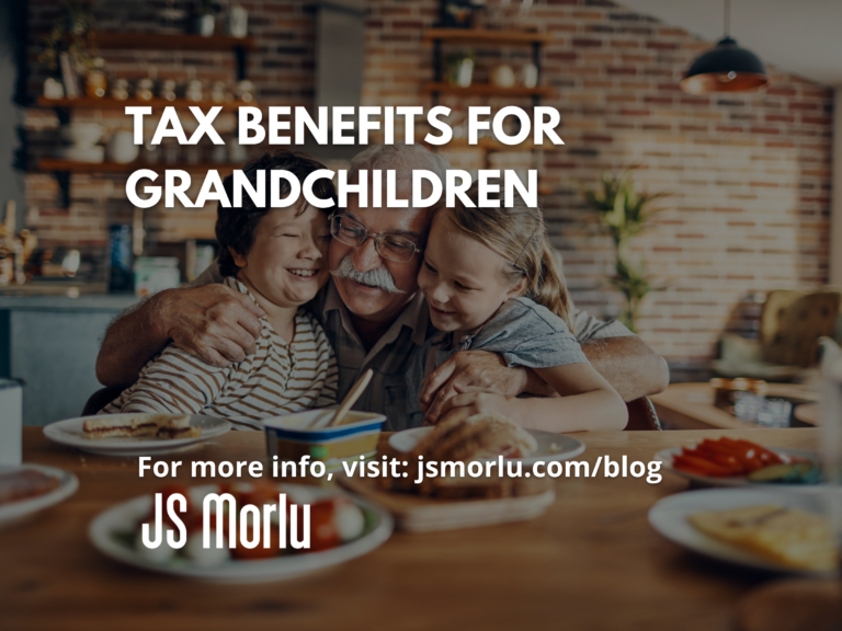 An elderly man affectionately embraces his two grandsons and granddaughter in a warm kitchen setting - Tax Benefits/Grandparents.