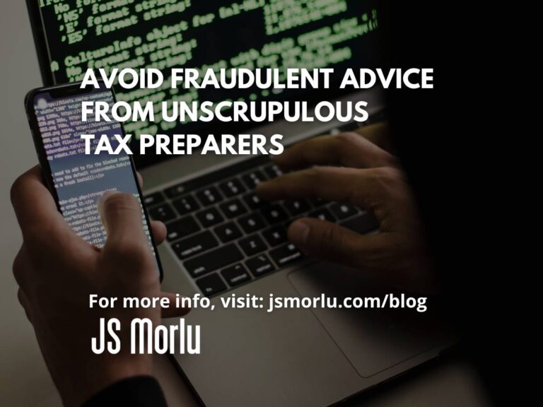 Person holding a smartphone in their left hand while typing on a laptop keyboard with their right hand - Tax Avoid Fraud/Scams.