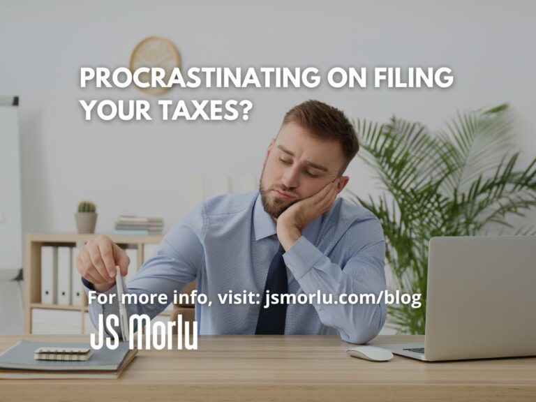Professional businessman sitting at desk with laptop and notebook, contemplating while holding pen - Filing Taxes
