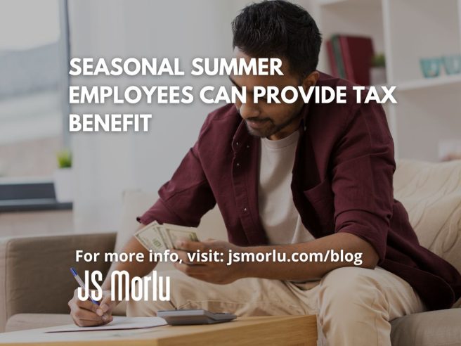 Man sitting at desk, writing on paper and holding cash - Tax benefit