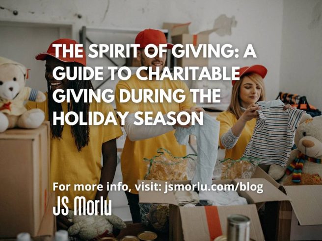 Two women and a man are standing in front of a large cardboard box filled with donated items. The women are smiling, while the man is holding a tshirt. This image represents the act of charitable giving and the joy that comes from helping others.