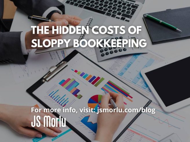 Two colleagues analyzing financial data: one reviewing a bar chart on a clipboard while pointing with a pen, the other taking notes on a small notepad. A calculator, laptop, and scattered paperwork sit on the table beneath the clipboard - sloppy bookkeeping.